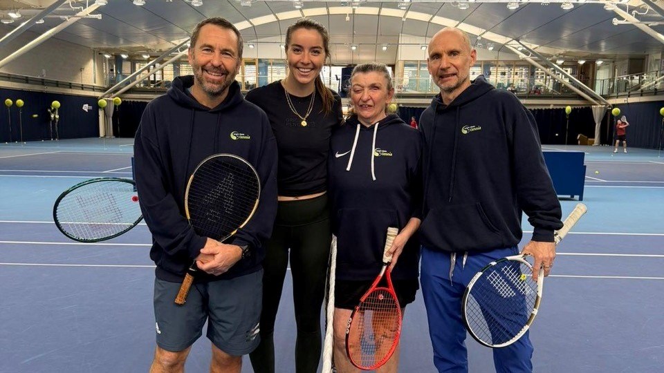 Four people, including Jodie Burrage and Tracy Compton on court and the National Tennis Centre 