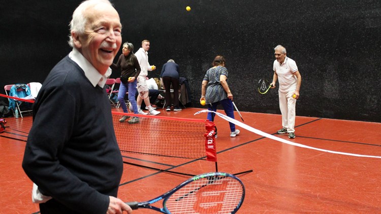 Seniors tennis players having fun on court at an inclusive session run by The Queen's Club Foundation