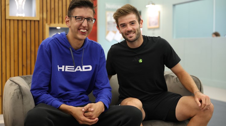 Luay and Jacob Fearnley sat on the sofa smiling at the camera