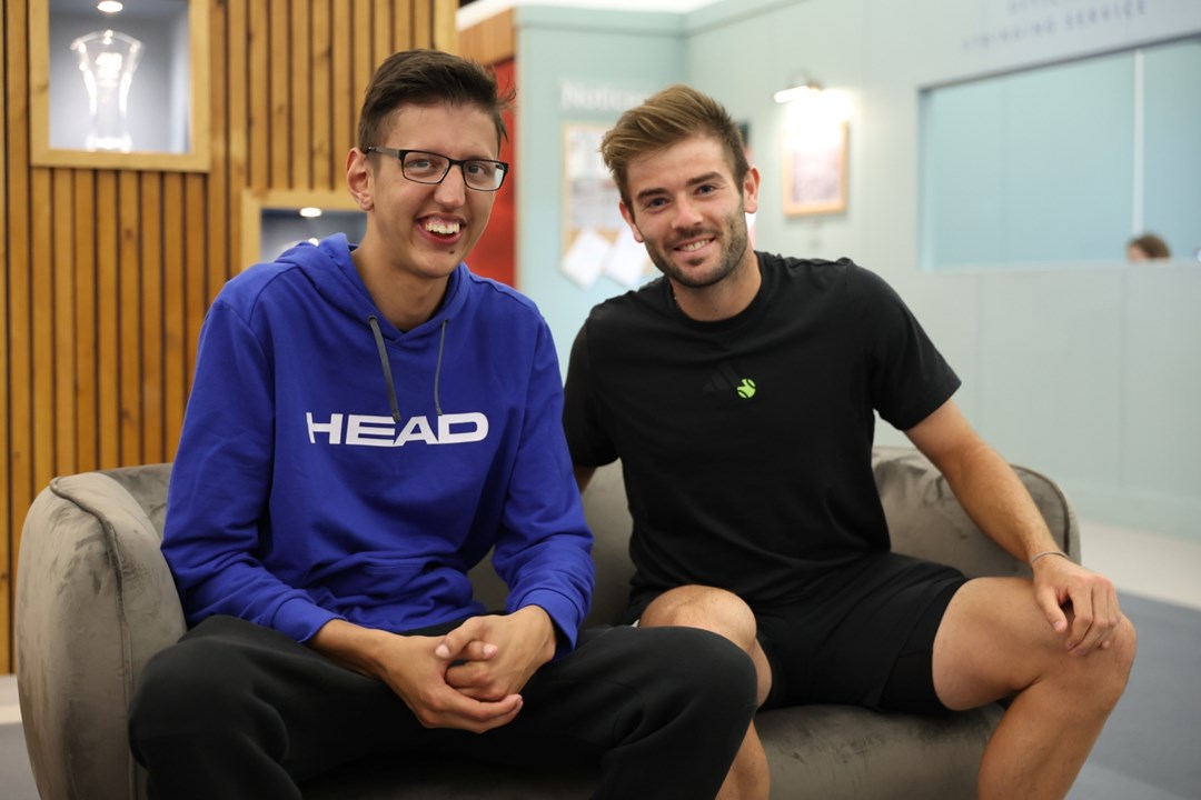 Luay and Jacob Fearnley sat on the sofa smiling at the camera