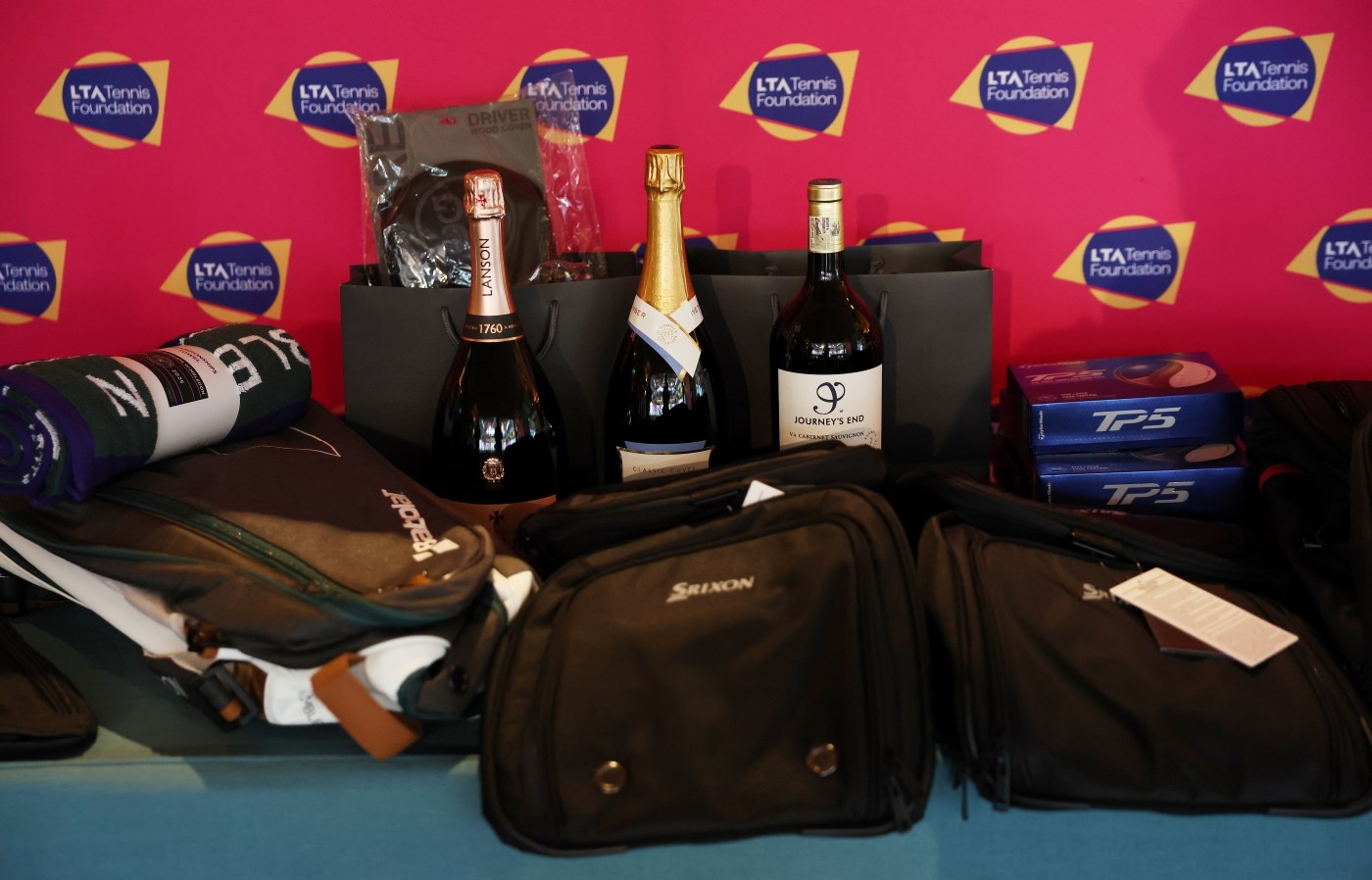Golf Day prizes, including bottles of Nyetimber, golf balls, and towels