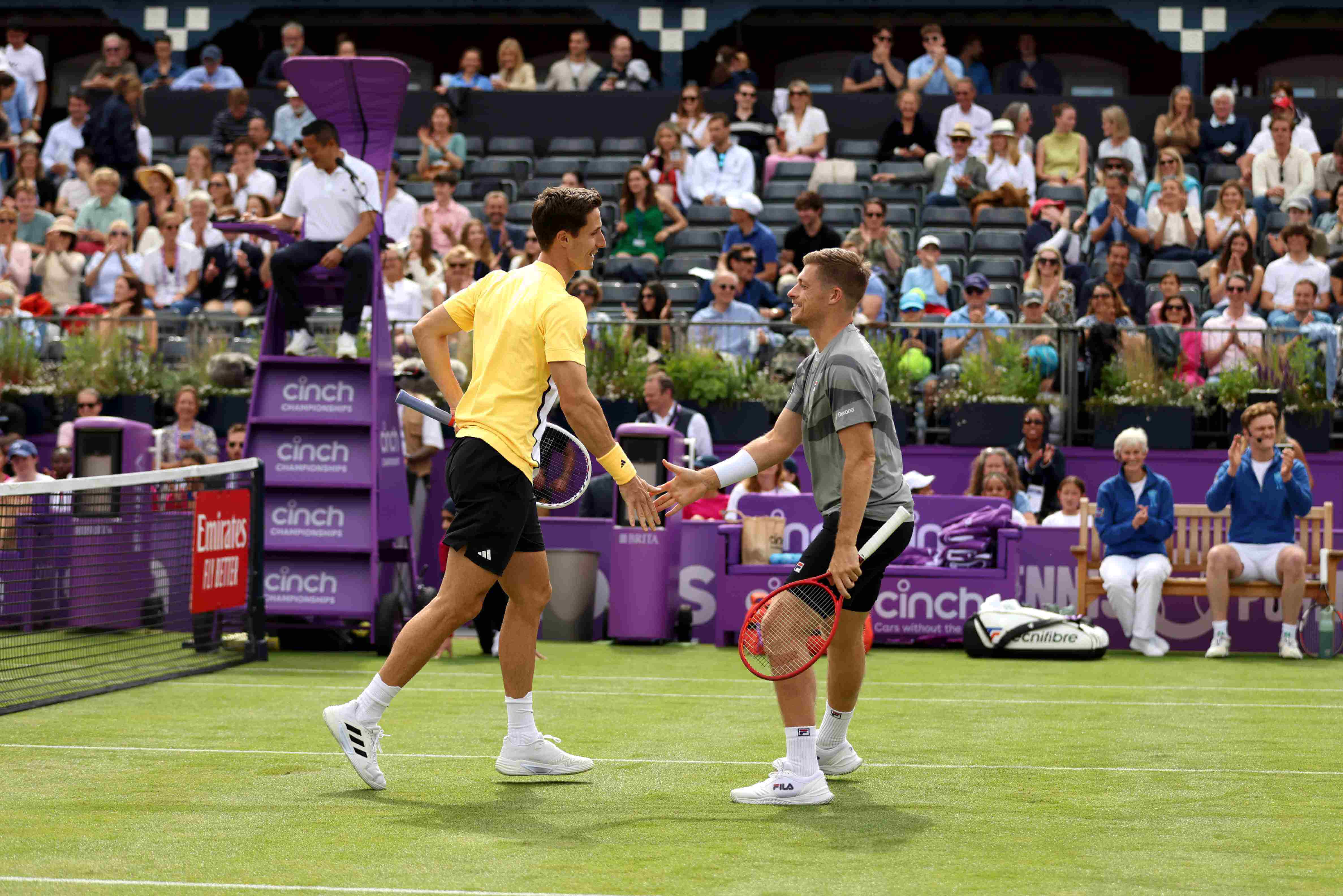Neal Skupski and Joe Salisbury high-fiving each other on court at the cinch Championships during the fan day exhibition match