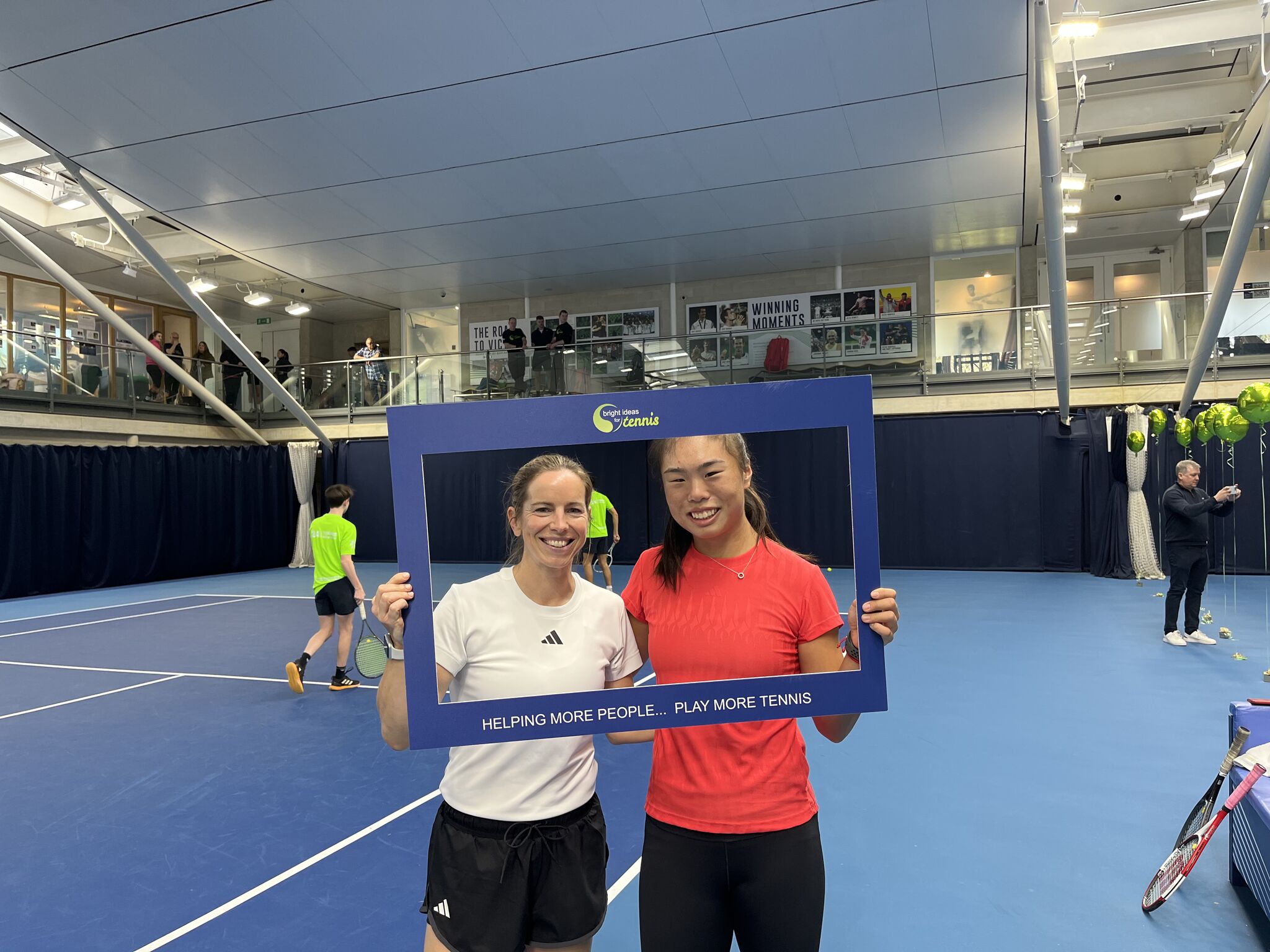 Katie O'Brien and Mimi Xu holding up a Bright Ideas for Tennis frame