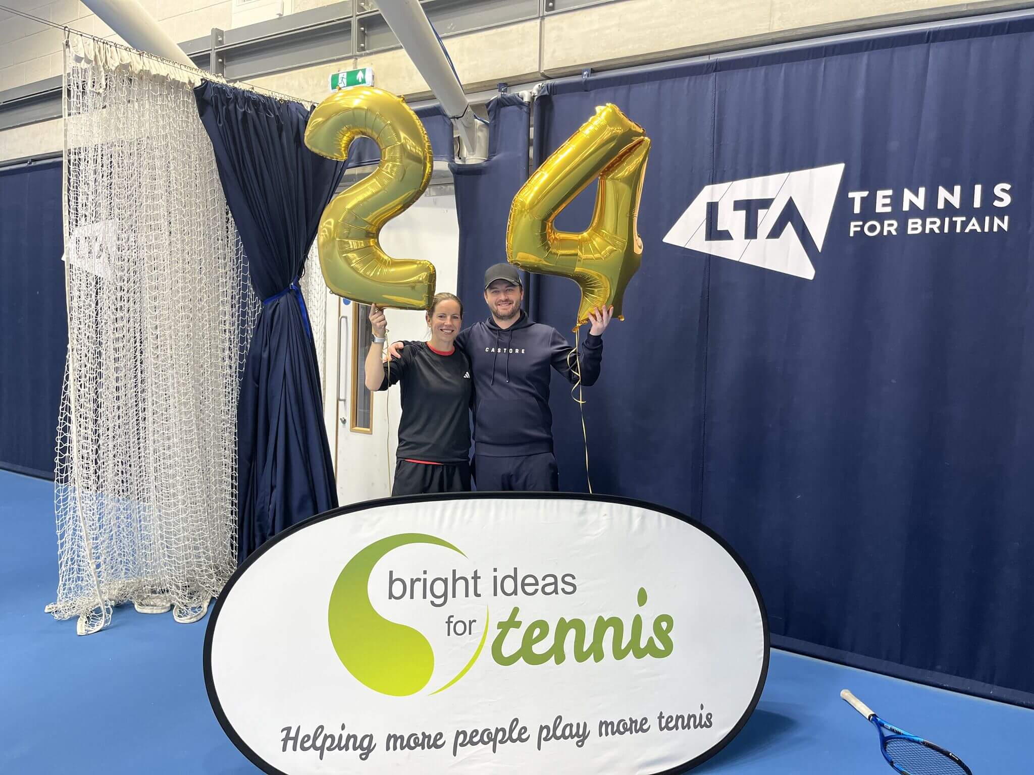 Katie O'Brien and Jonny O'Mara holding up '24' balloons for the 24 hour challenge