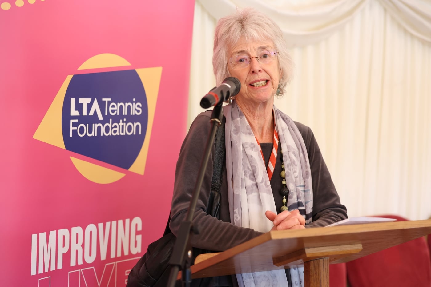Baroness Lister speaking at a lecturn