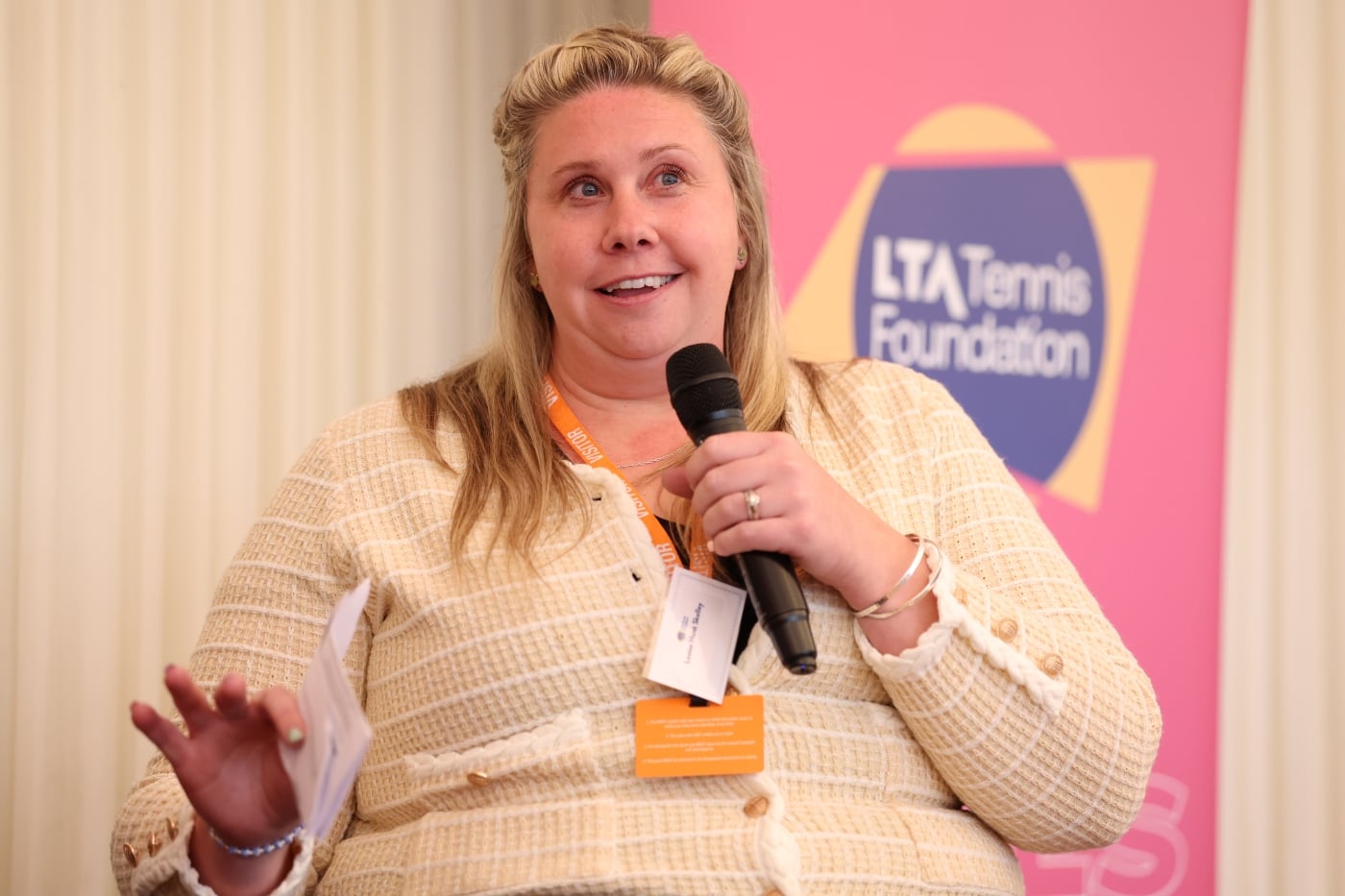 Louise Hunt-Skelley holding the microphone and speaking