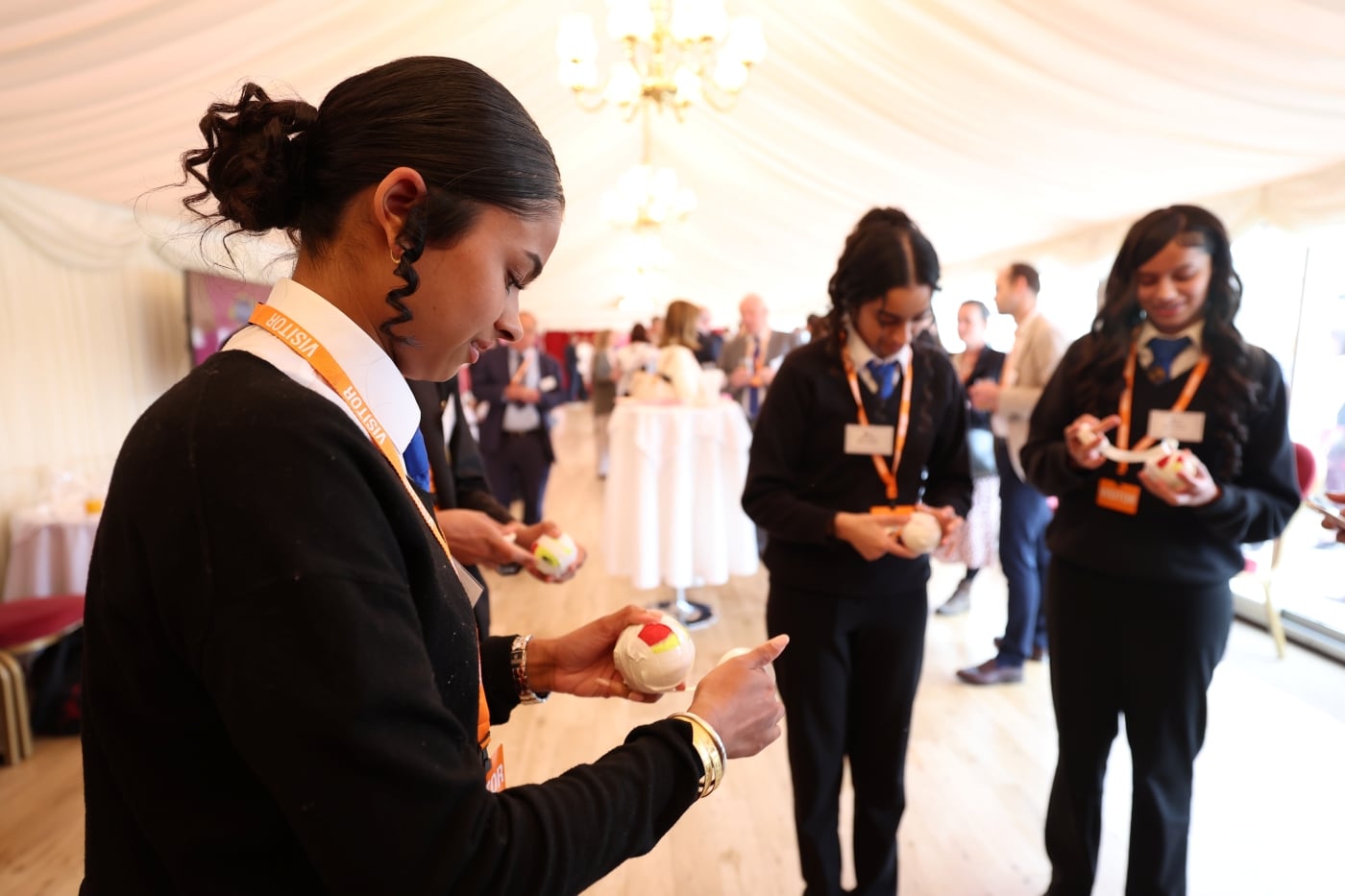 Students holding tennis balls at the reception