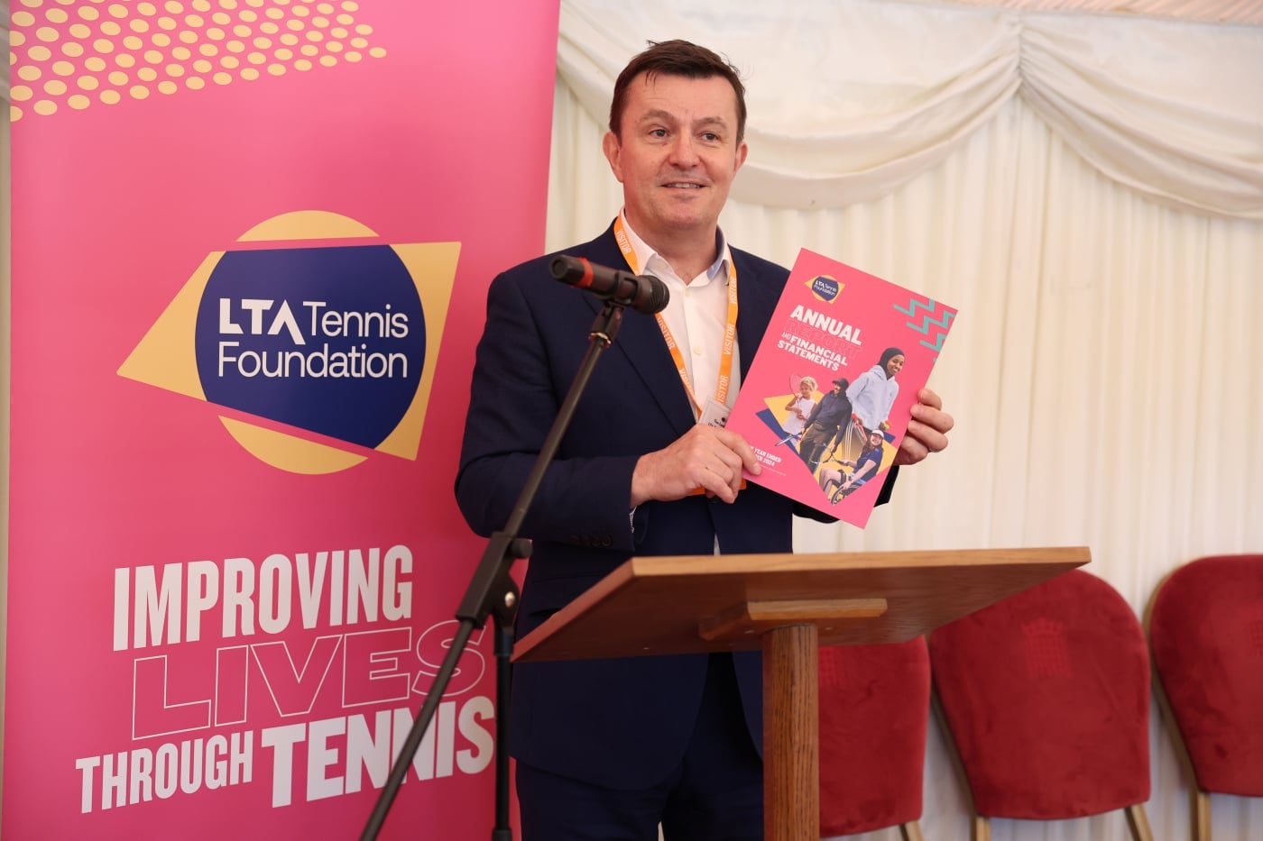 A speaker holding the LTA TF annual report