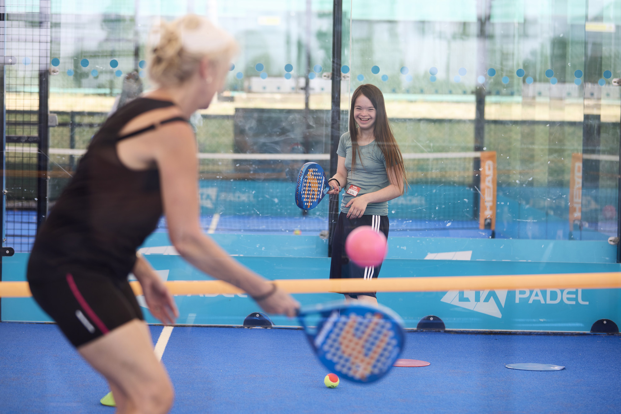 young girl smiling playing padel