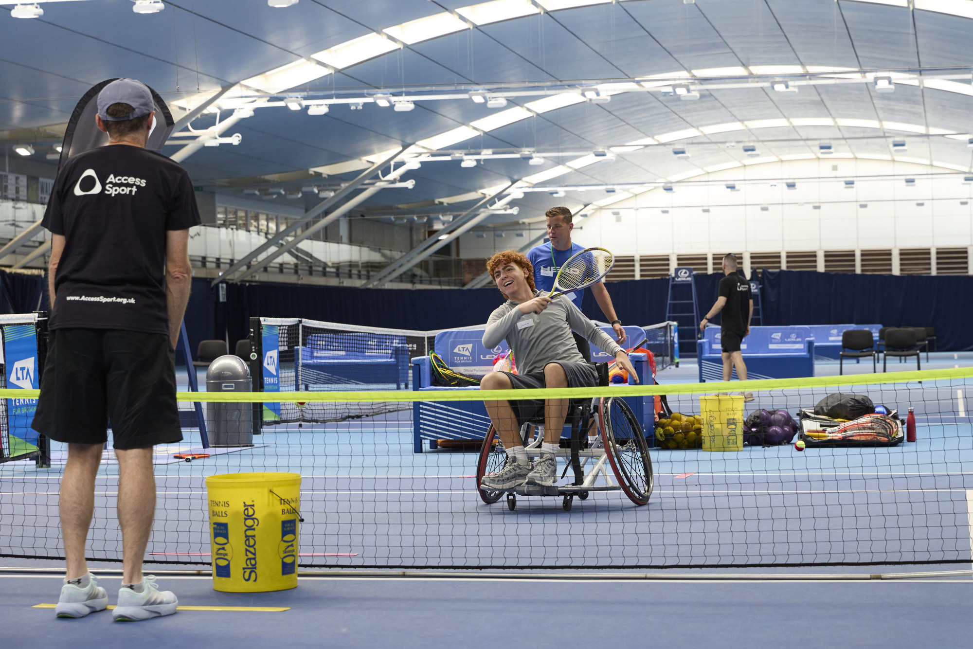 young man playing tennis in a wheelchair