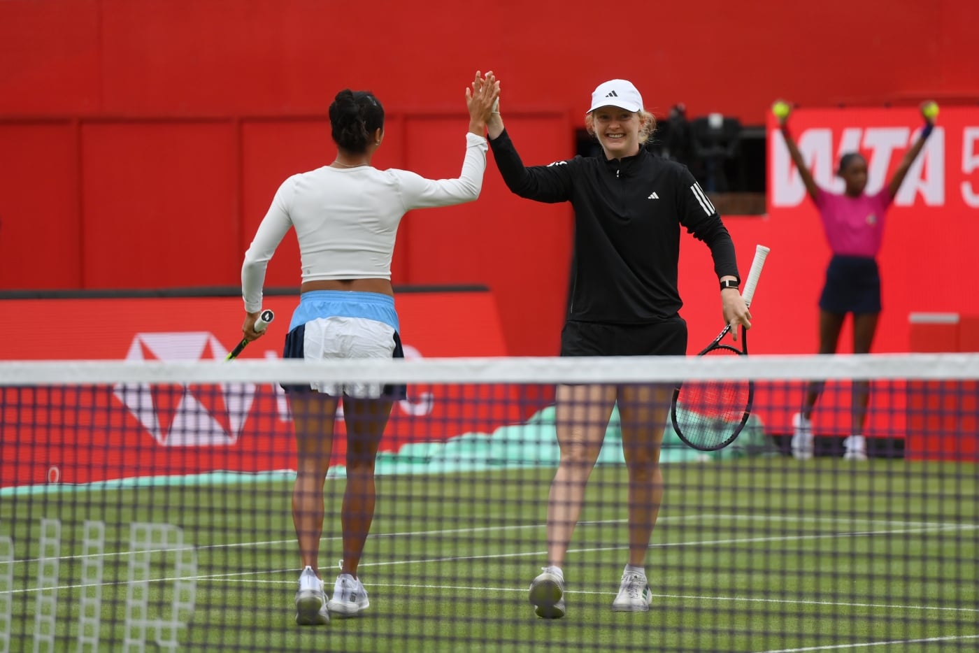 Fran Jones facing camera, giving Leyla Fernadez a high five 