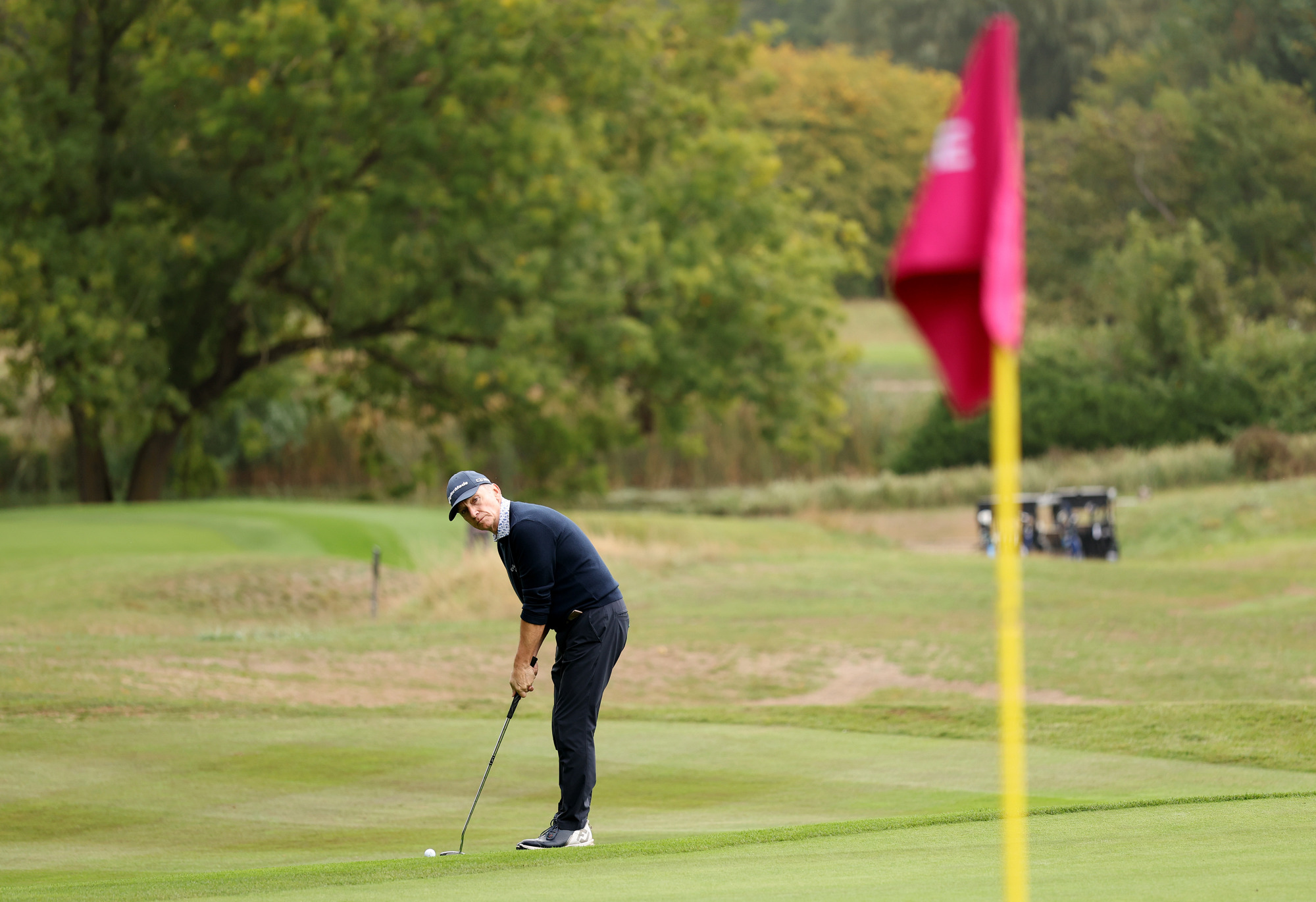 A man is preparing to chip onto the green