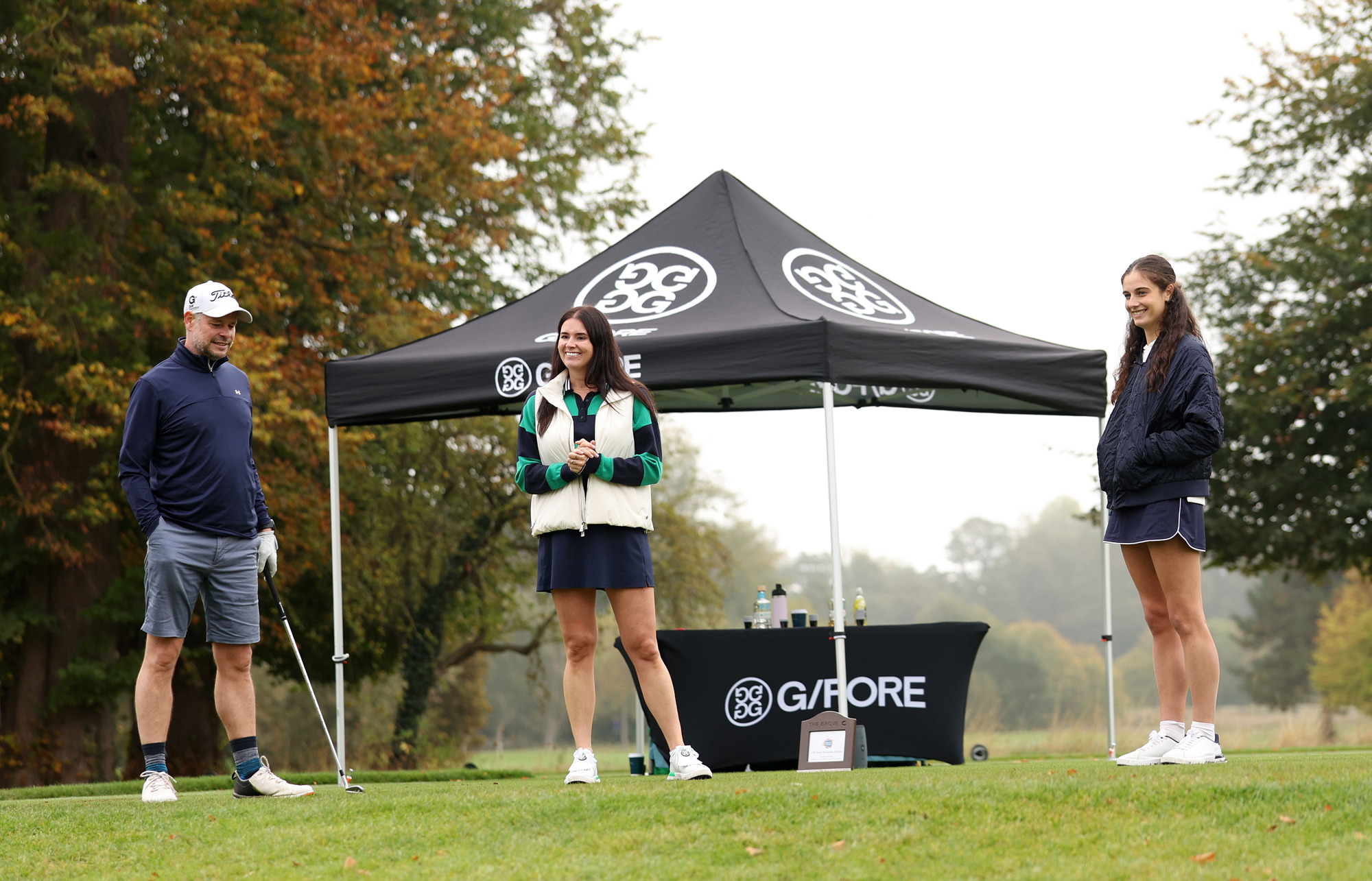 GFORE staff explain the closest to the pin challenge to a golfer