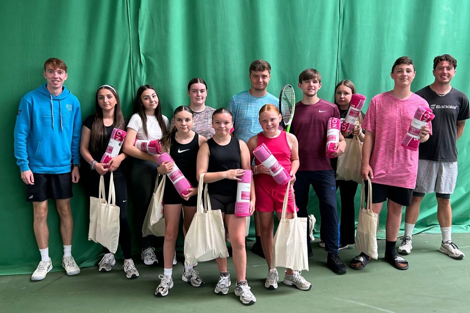 Group of children and young people with goody bags given to them at their summer scheme